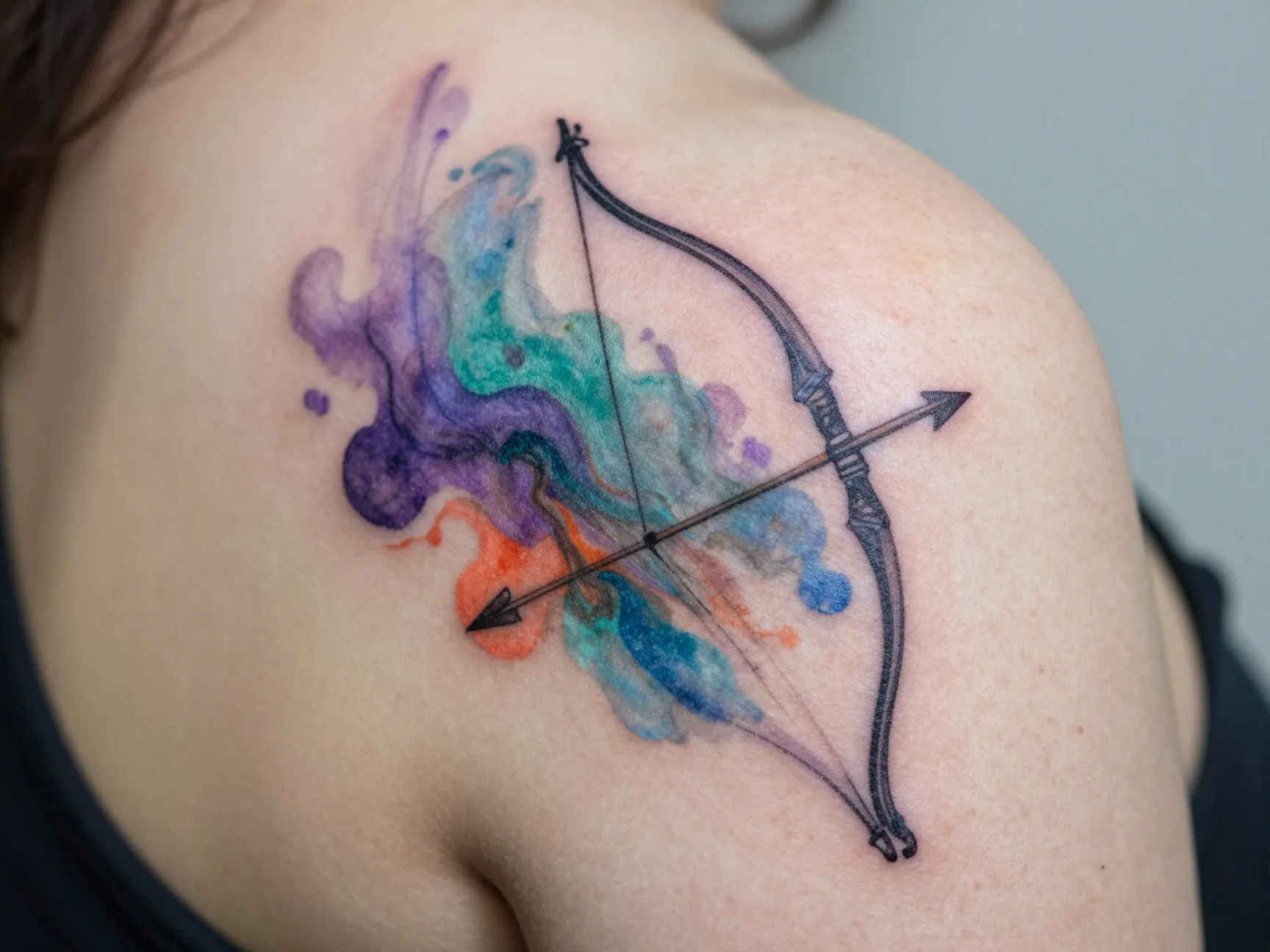 Watercolor bow and arrow tattoo