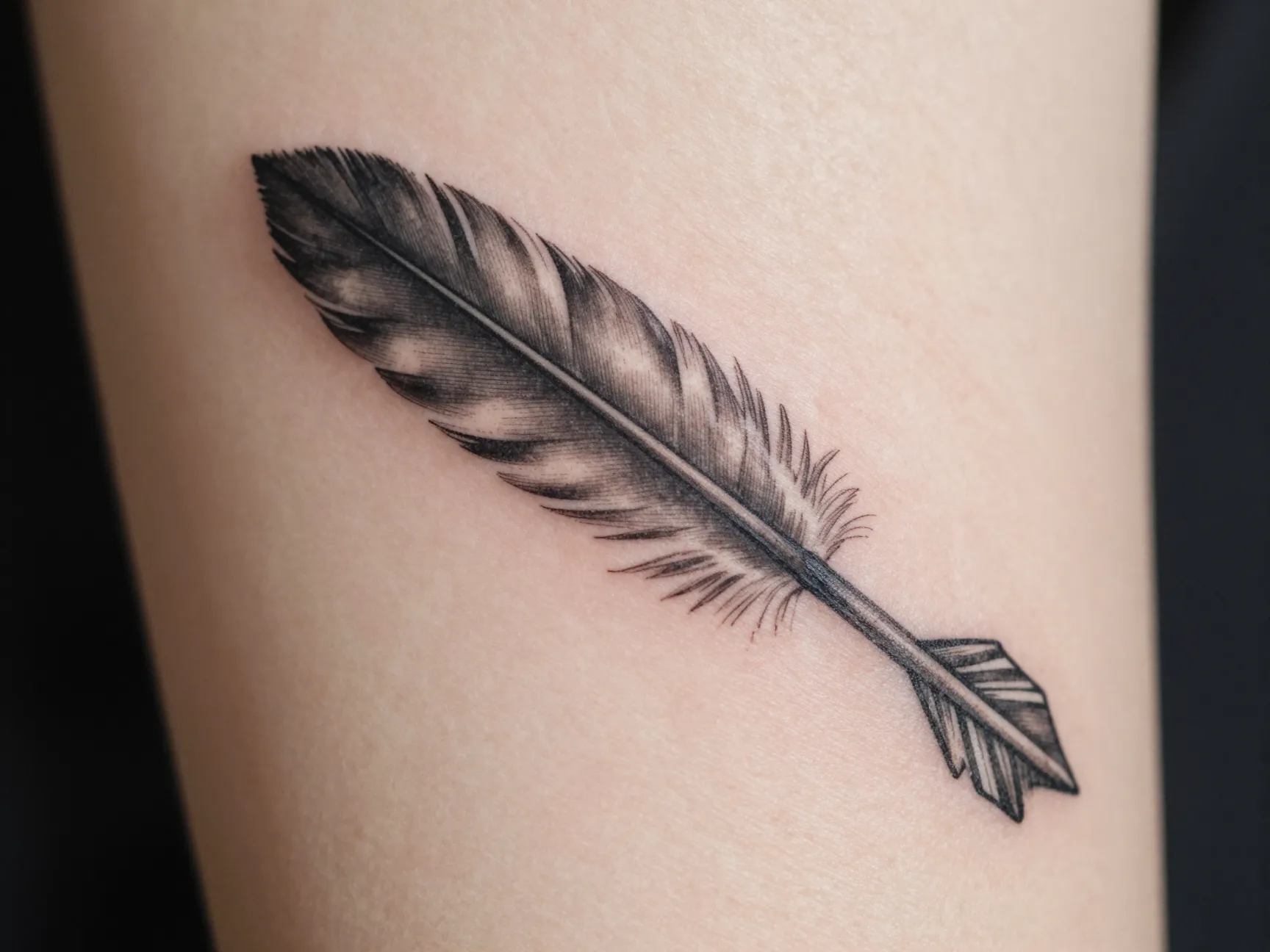 Arrow with feather detail tattoo